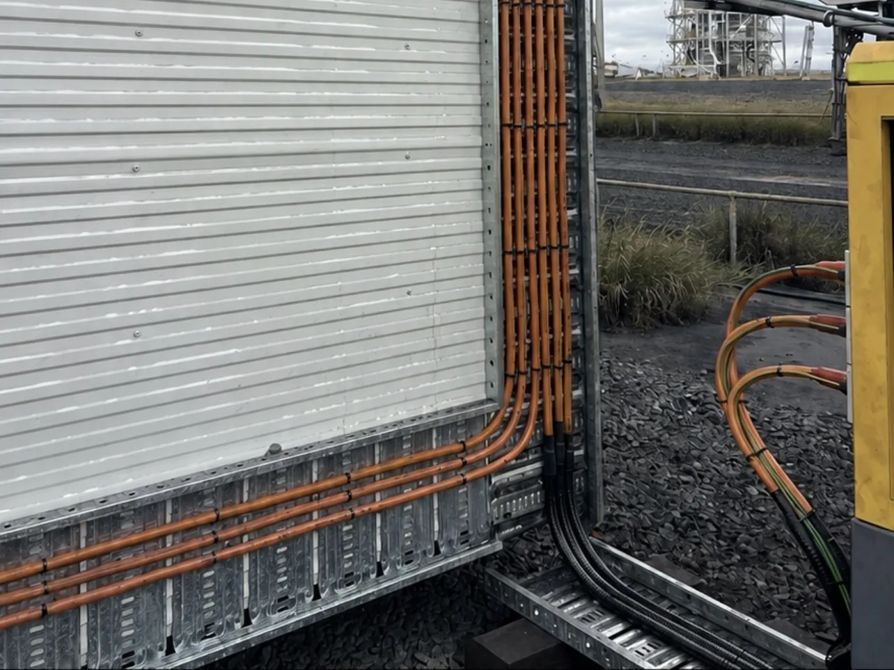 Mining cable run through cable tray up a fixed plant structure