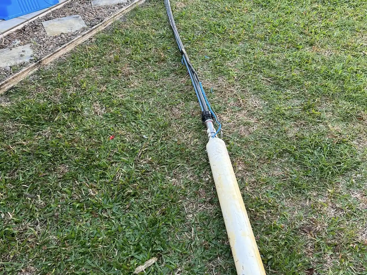 Underground service conduit run through a trench with the cable drawn in